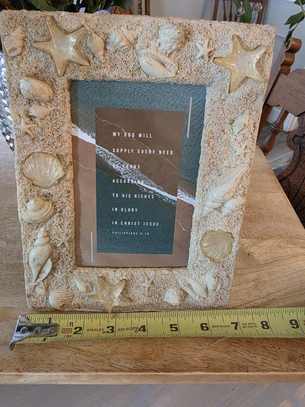 Textured beach picture frame decorated with real seashells and faux-sand finish